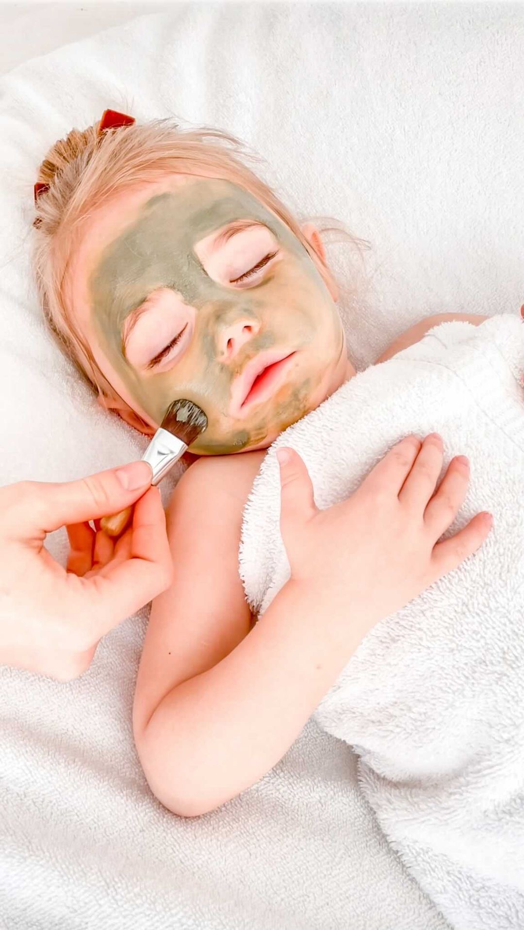 A younger guest enjoying a pamper facial