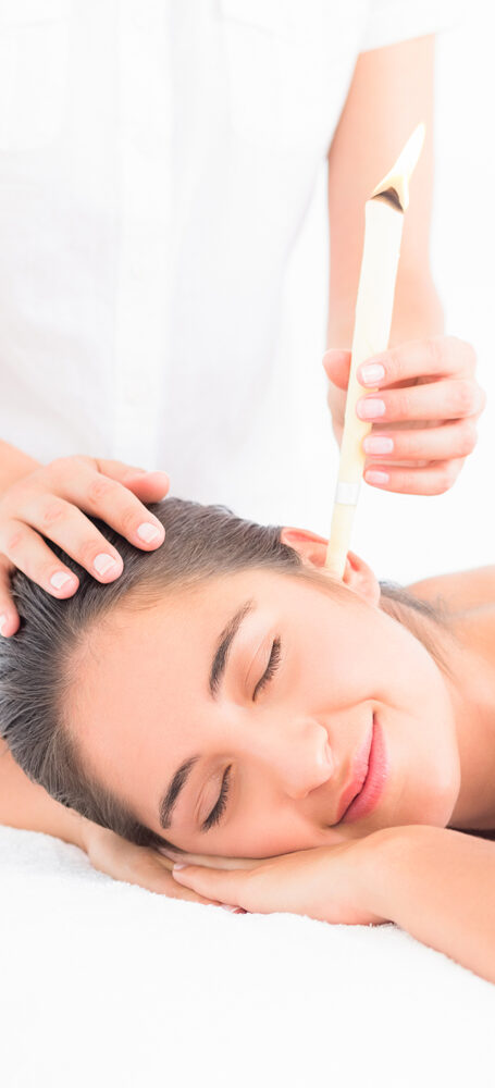 Client lying on her side during a Hopi ear candling treatment