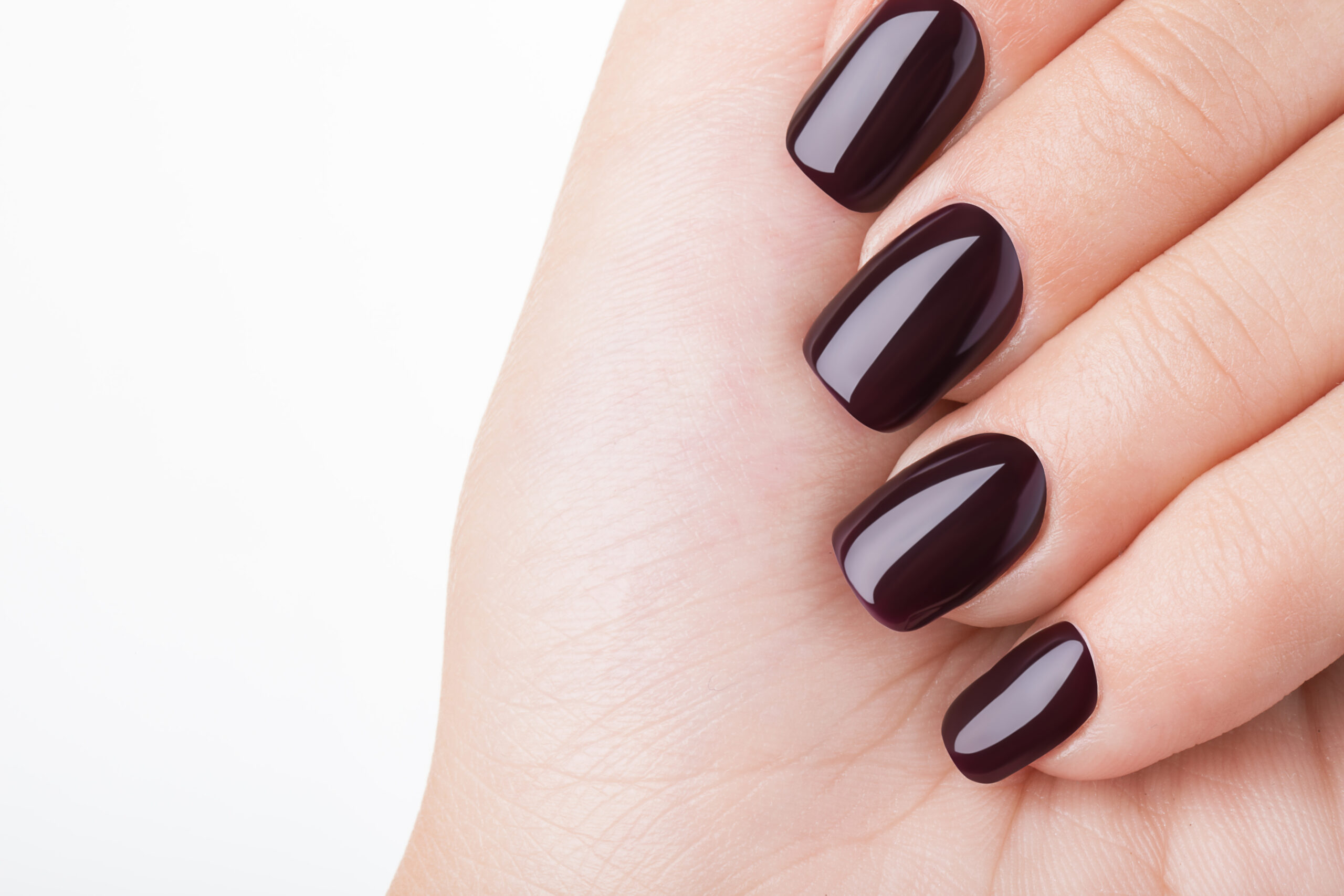 Glossy deep-coloured gel manicure